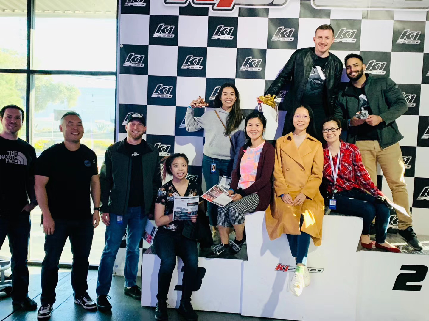 Team offsite at the go-kart track, podium celebration